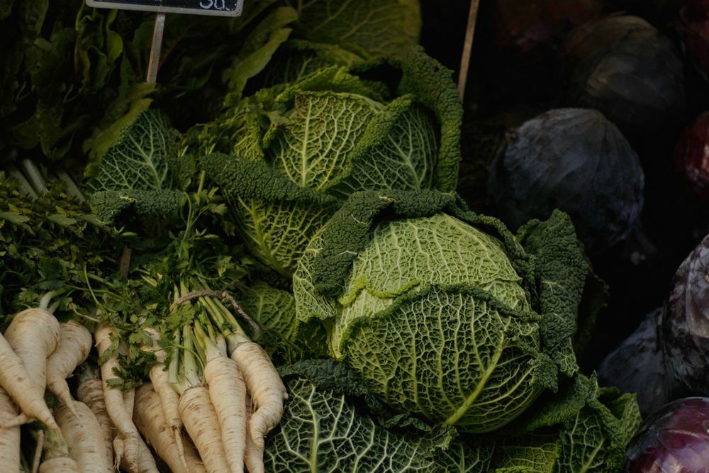Savoy cabbages and parsnips on a market stall